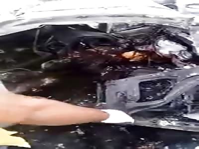 Workers Removing Totally Burned Bodies of 5 People from Burned-out Vehicle