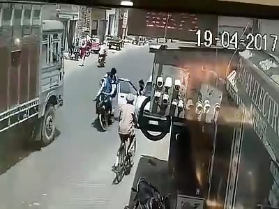 Two School Students Get Run Over by Truck after Colliding with Open Car Door