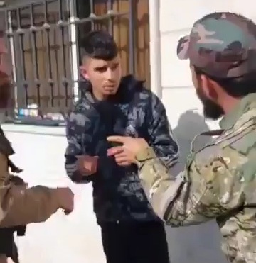 militants of the New Syrian Regime beating young suspect 