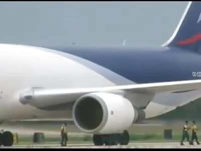 EMPLOYEE PASSES IN FRONT OF AIRPLANE TURBINE AND IS SUGGESTED