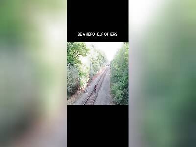 Man saves guy from inches away by getting hit by train 