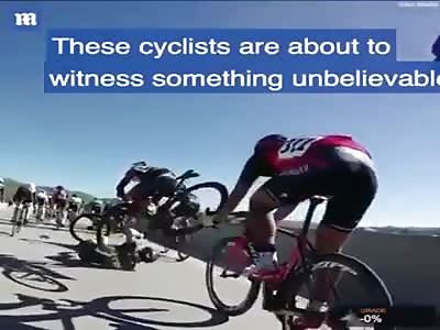 A cyclist nearly falls off a bridge following a collision with other riders!!