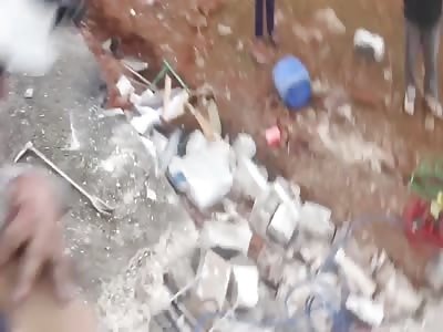 digging out corps of little kid and his moth after russian air strikes