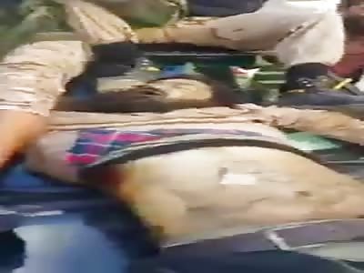 Haftar militia showing their dead enemy 