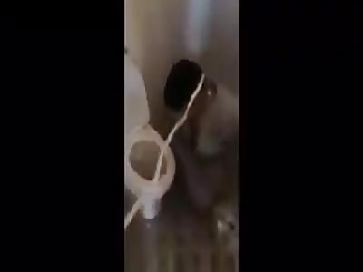 Iraqi soldier torturing and humiliating prisoner 