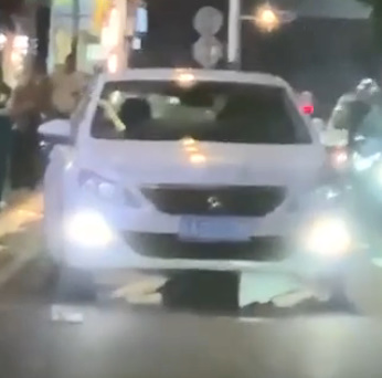 Girl laying on the street crushed by car