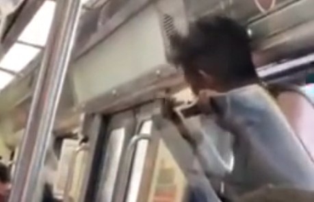Crazy man fighting at the ticket window of the Mexico City subway