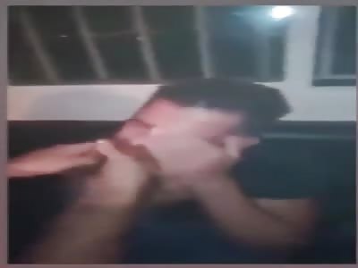 A Lebanese policeman tortures a young Syrian man by photos on his phone.