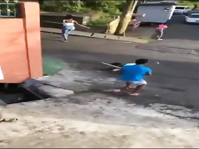 Woman is hit on the head with a stick.