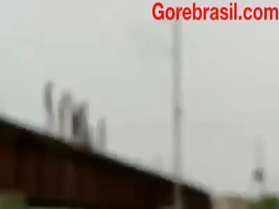Boys jumping off the bridge seconds before the train passes