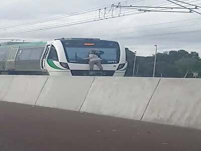 Guy Hitches A Ride On The Back Of A Speeding Train