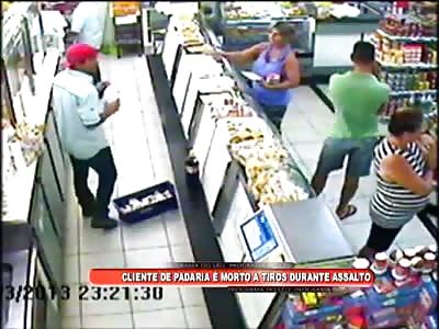 Man scares the bad guy when he gets his cell phone and is shot and killed