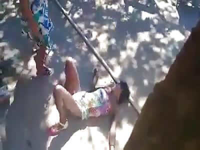 Mother hurts her daughter. With piece of wood