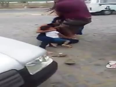 Fat ridiculous mug woman with son on her lap in front of a prison