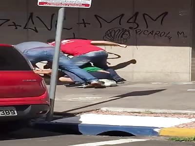 Man attacking woman is beaten by bystanders.