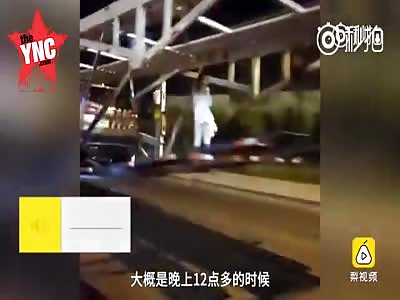 a woman in white hanging of a bridge 