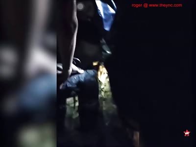 rescuers retrieve the body of a death youth after floods in South Sulawesi