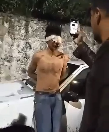 Blindfolded Thief with Hands Tied Gets Punishment