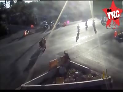 3 People on 1 bike get nailed by a passing car