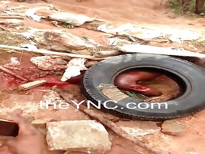 Thug in agony under rocks and tires as the gasoline is poured