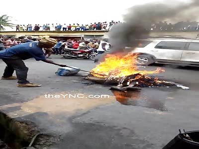 Kids watch as suspected criminal is burned in the street