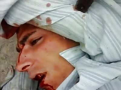 bloodied thug is threatened with a gun