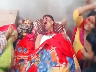 Dead young man beside his mother