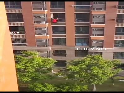 A Guy Falling Off A Tall Building In China.