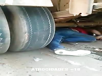 Biker enters from under a truck