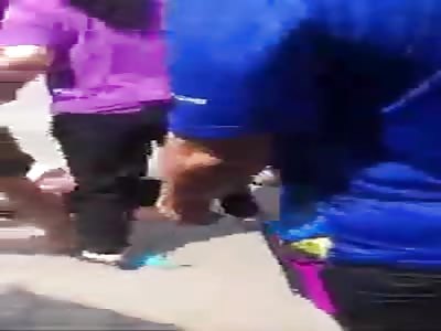 Angry Vietnamese wives try to strip mistress.