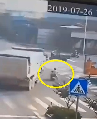 Huge Truck Parked on Scooter Rider.