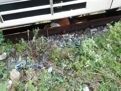 Dead old man under train