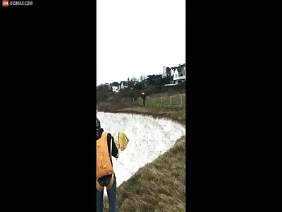 BASE jumper plummeting off cliff as parachute fails