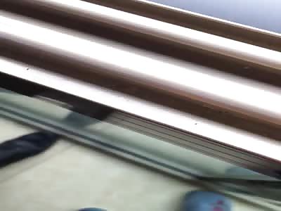 woman hung from the top of the building 