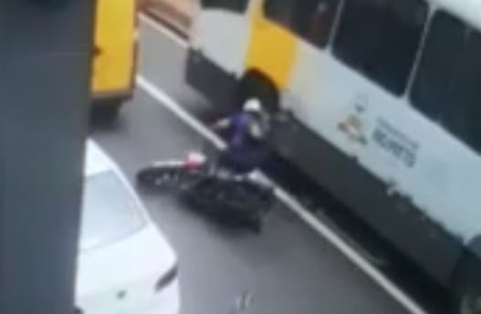 Biker Falls Under the Wheels of a Bus