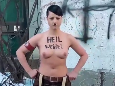 A topless Ukrainian as Adolf Hitler in front of the German embassy