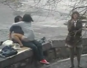 Friend waits while her friend gets tagged in public