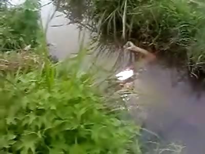 Drowned Corpse left under Water in a Little Creek