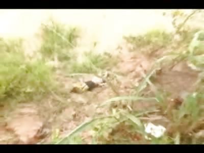 Dirty Dead Girl with Noose around Neck pulled from Dirt Hole