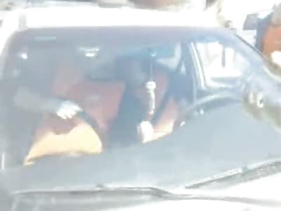 Wake Up! Curious Crowd gathers around 2 Men Executed in their Car