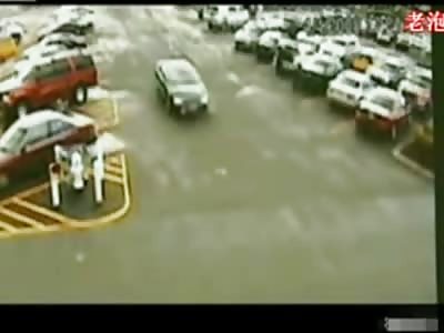 Female Drive Backing out Runs over Two People Nearly Killing Them