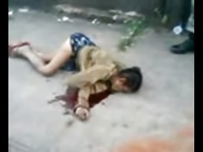 Boy tells the Story to Police Officer as he Stands over Dead Woman 