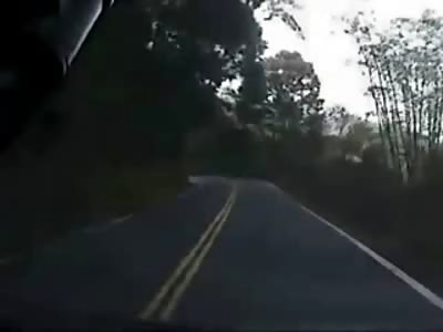 Guy on a Scooter Tries to Overtake Car on Curvy Road and Slams Head onto Speeding Car..