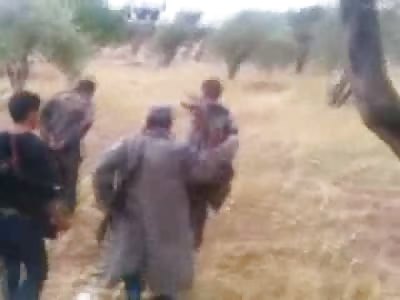 New: Trench Coat Wearing Captor Executes two Men with Machine Gun