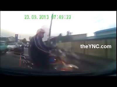 Old man on a Scooter wearing a Pink Helmet