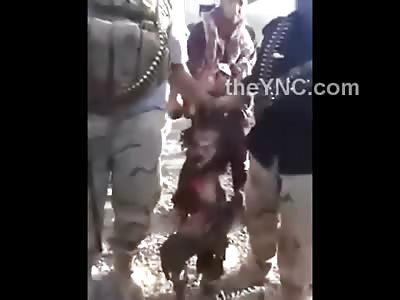 Posing for a Quick Photoshoot Holding the Head, Spine and Shoulder of a Dead Terrorist