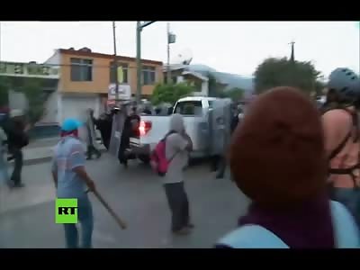 Protester in White Pickup Truck Intentionally Backs into and Runs over Two Riot Police