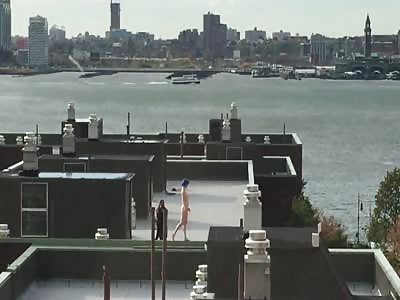 Naked girl with blue hair dancing on top of a building in the west village, NYC