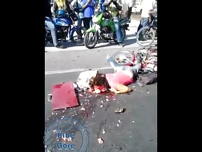 Woman dies with her head crushed by tractor-trailer.