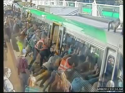 MANY PEOPLE PUSH TRAIN TO HELP 